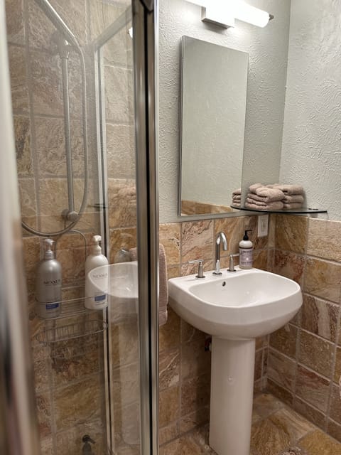 Combined shower/tub, hair dryer, towels, soap