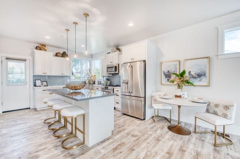 An island in the kitchen offers extended seating and an area to prep food.