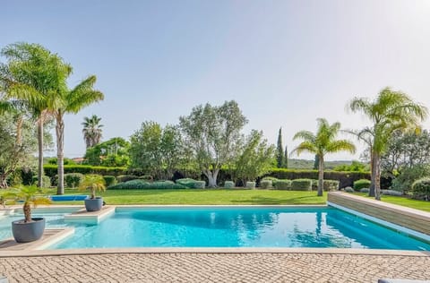 A heated pool, sun loungers