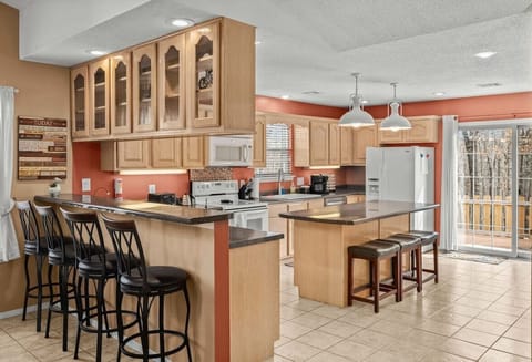 Fully equipped chef’s kitchen with spacious island, stainless appliances, & coffee bar for your culinary adventures.