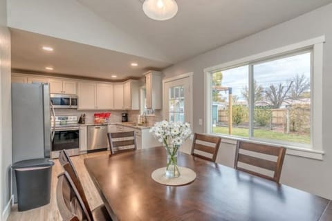 Light and airy dining room with window and door onto backyard.