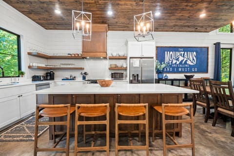 A modern, open kitchen setup with a spacious island and seating for everyone. Get ready to create and enjoy memorable meals together.