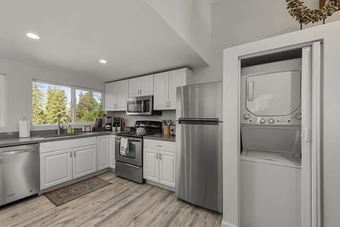The newly updated kitchen has stainless steel appliances and a laundry closet.