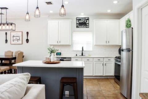 Experience the joy of cooking and entertaining in this inviting kitchen with an open concept. Relax in the comfortable island seating and rest easy with the added safety of a security camera/doorbell viewing panel.
