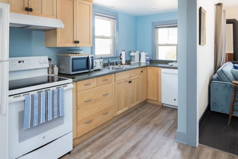 Fully equipped kitchen with all the essential dinnerware, glassware, silverware, and cookware