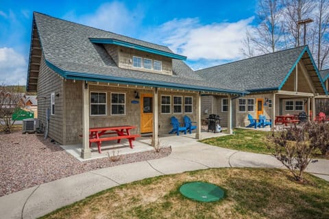 The patio has a picnic table, chairs and a propane BBQ.
