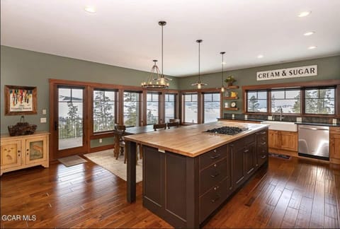 Large butcher block countertop with 5 stools