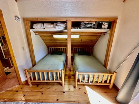 Two of three twin beds in the primary bedroom on the top floor
