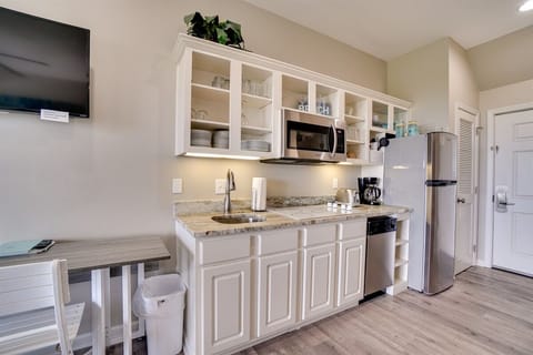 Kitchenette with cook top, fridge and microwave.