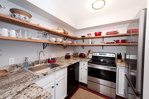 Kitchen fully stocked with dishware and cookware