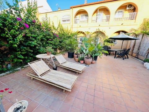 The bamboo lounge chairs in the Zen Zone garden area plus 2 tables and umbrella.