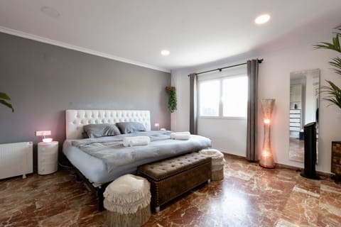 The Paris Suite (Emperor Bed), 65” TV, Surround Sound, and closet space.