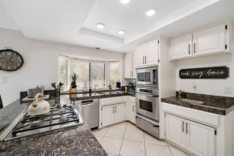 Kitchen with Gas Stove, Microwave, Oven, Toaster, and Coffee Makers