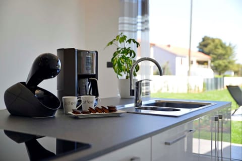 Fully equipped kitchen area of Medulin luxury pool villa with the espresso machine and coffee maker for vacation