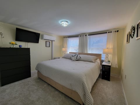 2nd floor bedroom with 1 king bed and smart TV.