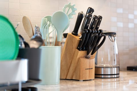 fully equipped kitchen with high-quality knives, essential cooking tools