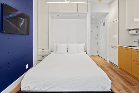Guests sleep on a comfy queen-size mattress topped with high-end pillows and bedding; moreover, the smart European-style Murphy bed easily slides into the wall creating space and comfort.