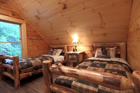 2nd bedroom on upper level has a queen and 2 twin beds