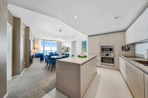 From the kitchen island you look out to the living room with panoramic windows.