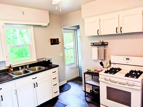 Enjoy the 4-burner gas stove.  The door leading to the back yard..  
