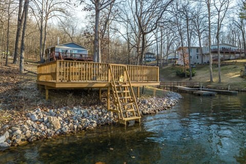 Fish or swim from this large lakeside deck with ship's ladder extending into the water. The dock to the right belongs to neighbors and isn't available for use.