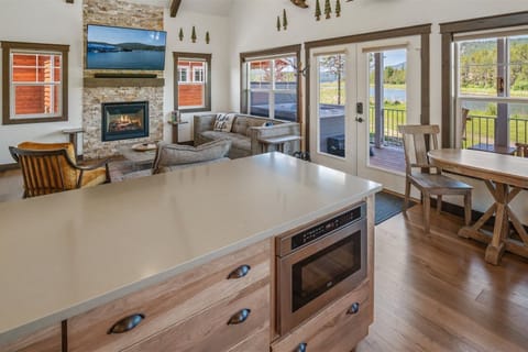 Living room and kitchen off the riverside entry way and gas fireplace