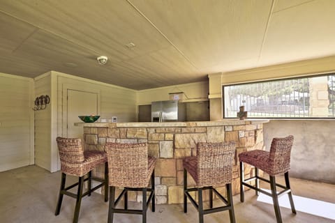 Try your hand at mixology behind this outdoor bar with fridge!