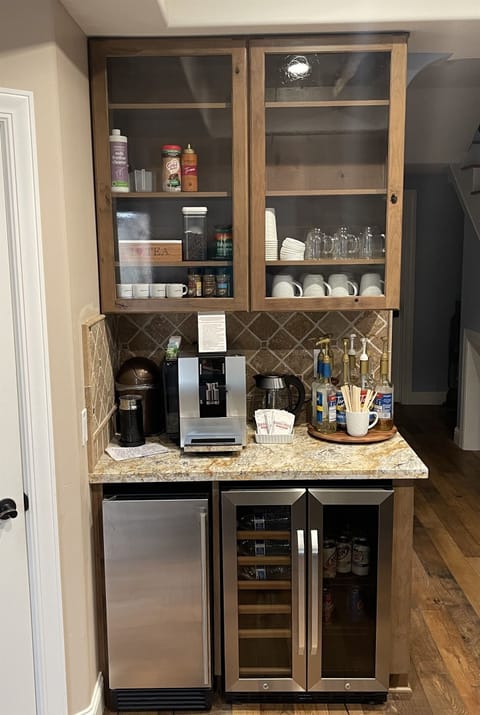 Jura super-automatic espresso/coffee maker with attached milk refrigerator for lattes/macchiatos. We supply whole dark roast beans, sweeteners, flavored syrups. We also have drip coffee maker and filters stored in pantry.