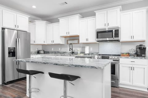 A bright kitchen with a large island—perfect for cooking, dining, or gathering with friends.