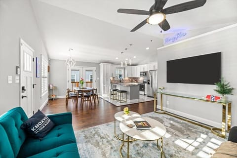 Welcome to the heart of the Harvey House, an inviting living room with a big Smart TV and plenty of space to relax.