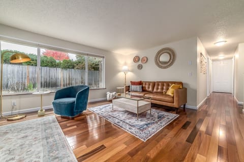 Living room with leather sofa and 360 swivel chairs.