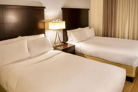 Unwind in crisp double queens after a busy day.