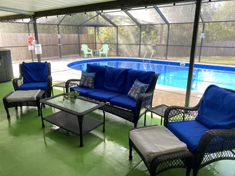 Screened in Pool, wall mounted TV, Grill, Dining Table, lounge chairs, couch 