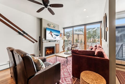 Unwind in your stylish living room with mountain views, cozy fireplace, and comfortable seating after your alpine adventures.