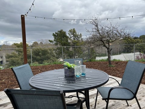 The patio is furnished with comfortable seating and a table, perfect for dining al fresco.