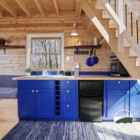 Natural light pours into the blue and gold kitchen. Ready for you to make memories