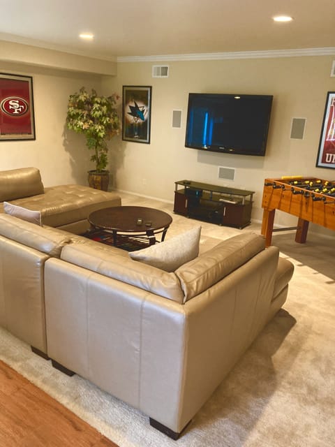Gorgeous Living Room with U shaped sofa, TV, Foosball