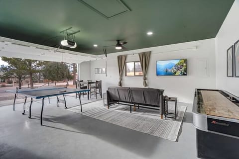 Perfect for family/friendly game nights, the garage game room is incredibly equipped with a ping pong table, shuffleboard, a large Smart TV, and a futon for additional relaxation..