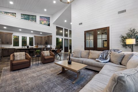 Enjoy quality time with friends and family in a chic living area adorned with cozy seating, providing direct access to the inviting patio that lies just behind.