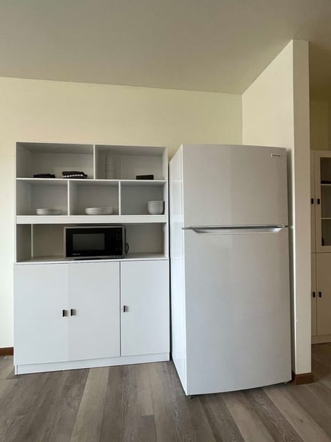 Fridge, microwave, coffee/tea maker, cookware/dishes/utensils