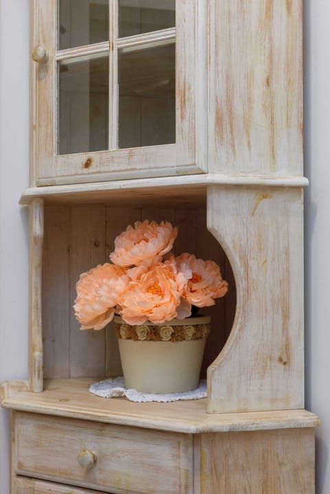 A rustic cabinet with flowers, adding a vintage charm to the interior.
