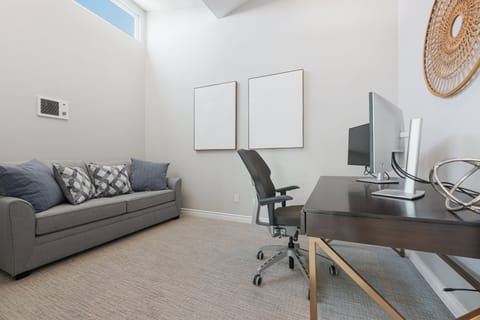 Off of the living room is a room with a full size sofa bed and an office desk. The computers are no longer in the home.