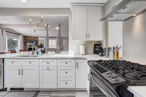 Open concept living and dining area surrounded with big glass doors and window overwiewing the Pikes peak mountains will make you think to come back and book our home again!