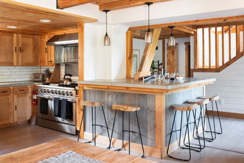 Kitchen features modern appliances and bar seating.