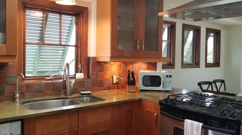 4 burner gas range, vent hood, countertop microwave and undercabinet lighting.