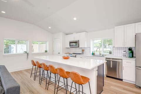 Kitchen large island with seating for 6, and seating for 4 at the back corner, plus seating for 4-10 outside on the patio. Kitchen comes stocked with everything you need to make a basic meal.