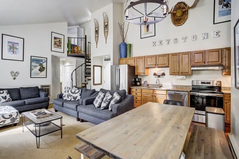 Spacious living room with sofa, fireplace, and dining area combined.