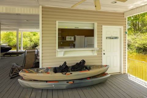 Two Kayaks Sit In Front of Kitchenette Bar