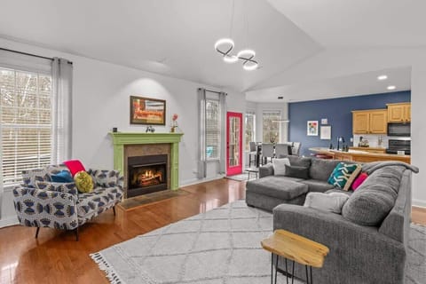 Unwind in the open‑concept living area with a plush sectional, 65″ smart TV & cozy fireplace—the perfect spot to relax after a day on the trails.