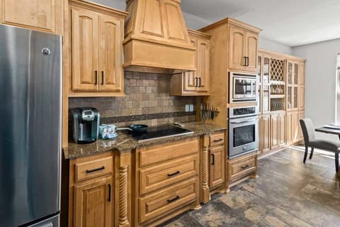 Prepare delicious meals in the fully-equipped gourmet kitchen, featuring top-of-the-line appliances and spacious countertops.